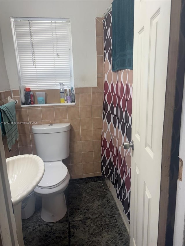 2530 Washington St, Hollywood, FL 33020 - bathroom with tile walls, toilet, a wainscoted wall, tile patterned floors, and curtained shower