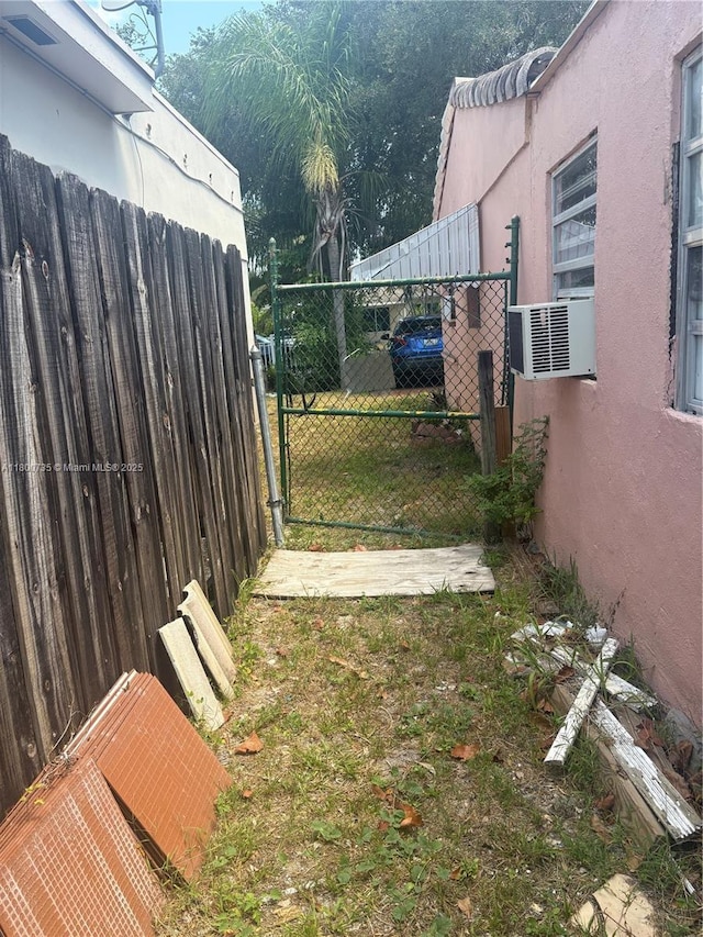 2530 Washington St, Hollywood, FL 33020 - view of yard featuring fence, a gate, and cooling unit