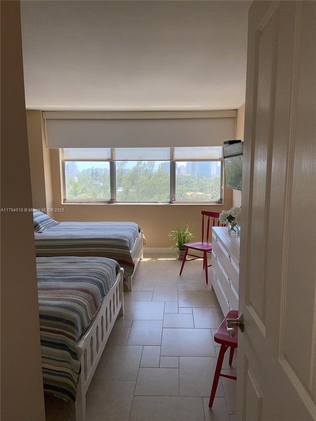 3180 S Ocean Dr Unit 716, Hallandale Beach, FL 33009 - tiled bedroom with multiple windows and baseboards
