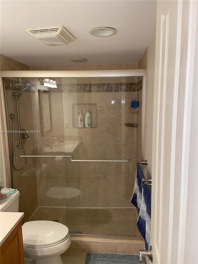3180 S Ocean Dr Unit 716, Hallandale Beach, FL 33009 - full bathroom with vanity, toilet, a stall shower, and tile patterned floors