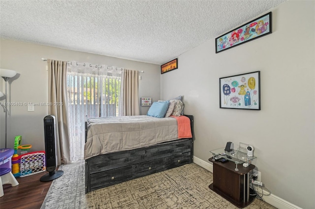2323 NW 37th Ave, Coconut Creek, FL 33066 - bedroom featuring a textured ceiling and wood finished floors