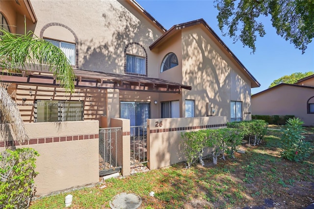 2323 NW 37th Ave, Coconut Creek, FL 33066 - view of front of property featuring stucco siding and a gate