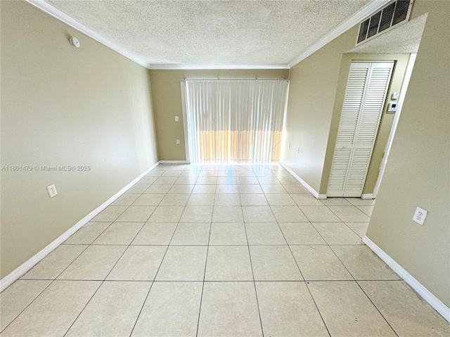 1141 Lake Victoria Dr Unit E, West Palm Beach, FL 33411 - empty room with ornamental molding, a textured ceiling, light tile patterned floors, and baseboards