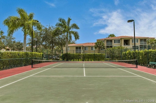 1141 Lake Victoria Dr Unit E, West Palm Beach, FL 33411 - view of tennis court featuring community basketball court and fence