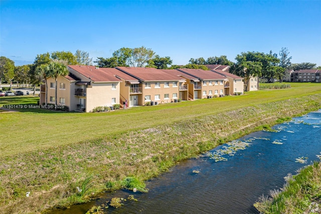 1141 Lake Victoria Dr Unit E, West Palm Beach, FL 33411 - rear view of house with stucco siding and a yard