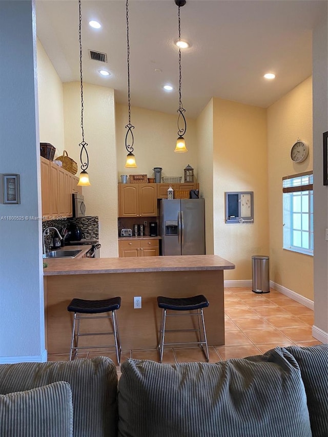 13135 SW 218th Ter, Miami, FL 33170 - kitchen with appliances with stainless steel finishes, a sink, a breakfast bar, a peninsula, and recessed lighting