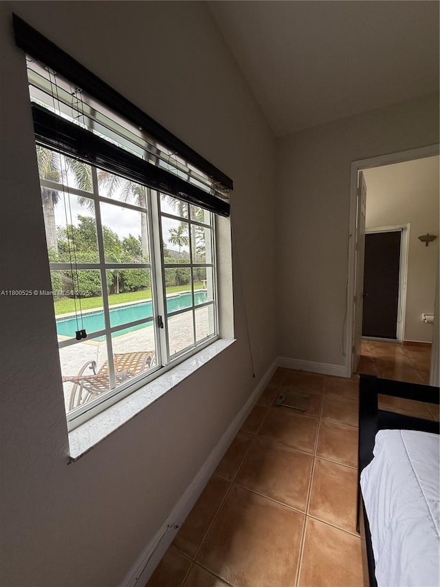 13135 SW 218th Ter, Miami, FL 33170 - unfurnished bedroom with tile patterned flooring, lofted ceiling, baseboards, and access to outside