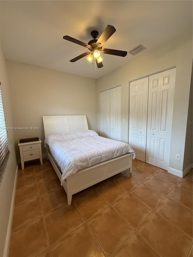 13135 SW 218th Ter, Miami, FL 33170 - tiled bedroom featuring two closets, ceiling fan, and baseboards