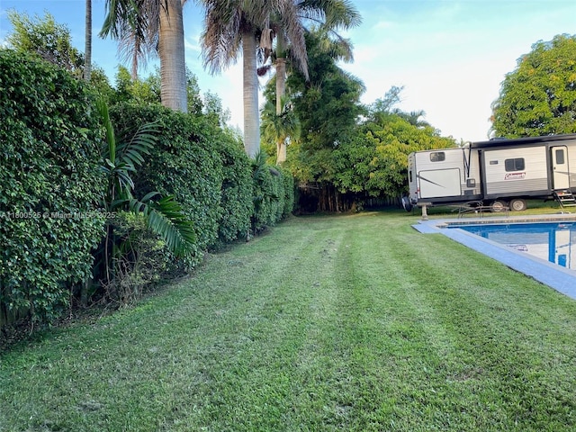 13135 SW 218th Ter, Miami, FL 33170 - view of yard with an outdoor pool, an outdoor structure, and a storage unit