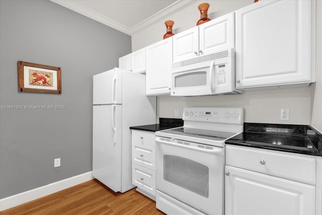 2950 Lucayan Harbour Cir Unit 107, Kissimmee, FL 34746 - kitchen with white appliances, ornamental molding, dark countertops, light wood finished floors, and white cabinetry