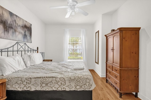 2950 Lucayan Harbour Cir Unit 107, Kissimmee, FL 34746 - bedroom featuring light wood-type flooring, baseboards, and ceiling fan