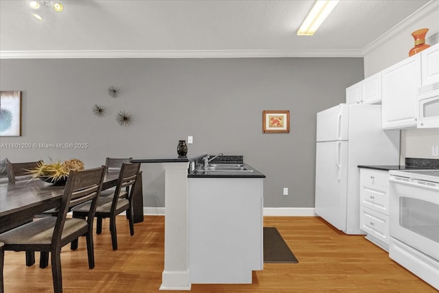 2950 Lucayan Harbour Cir Unit 107, Kissimmee, FL 34746 - kitchen featuring white appliances, a sink, ornamental molding, dark countertops, and white cabinetry
