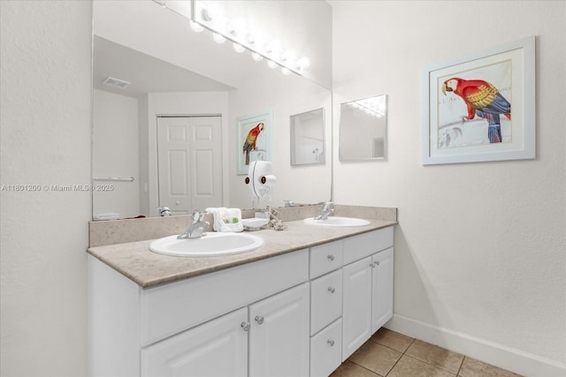 2950 Lucayan Harbour Cir Unit 107, Kissimmee, FL 34746 - full bathroom with tile patterned flooring, double vanity, and baseboards