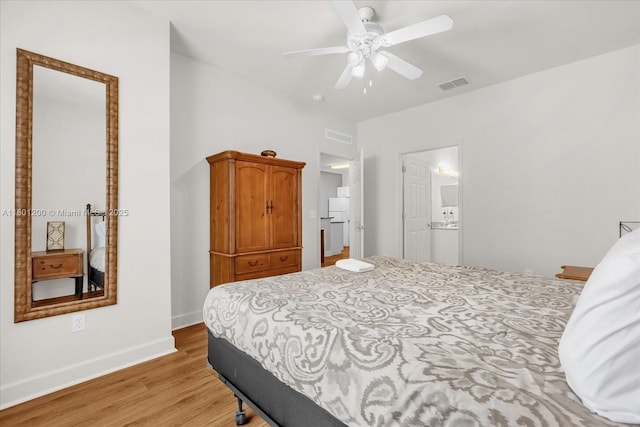 2950 Lucayan Harbour Cir Unit 107, Kissimmee, FL 34746 - bedroom featuring light wood-style flooring, baseboards, ceiling fan, and connected bathroom