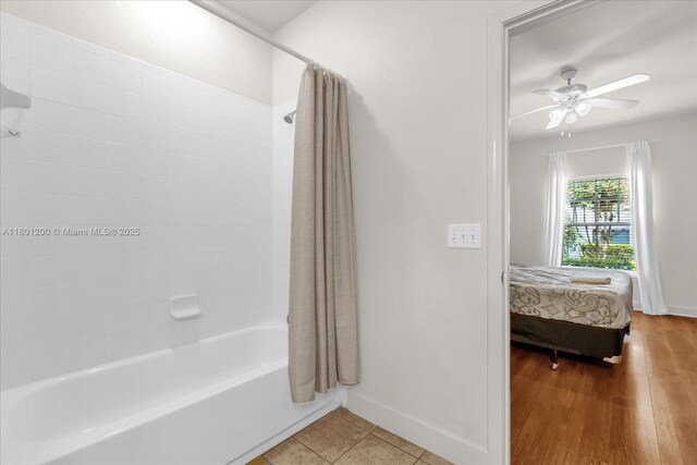 2950 Lucayan Harbour Cir Unit 107, Kissimmee, FL 34746 - full bathroom featuring baseboards, a ceiling fan, shower / bath combo, ensuite bath, and wood finished floors