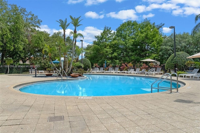 2950 Lucayan Harbour Cir Unit 107, Kissimmee, FL 34746 - community pool featuring a patio and view of scattered trees