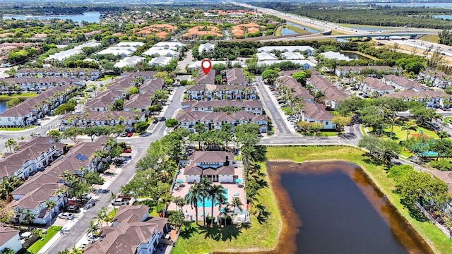 aerial view of property's location featuring nearby suburban area and a large body of water
