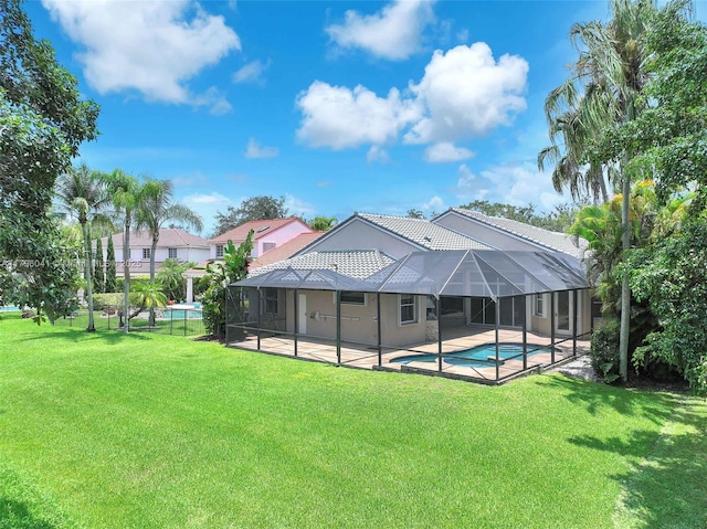2623 Oakbrook Dr, Weston, FL 33332 - back of property with an outdoor pool, a patio, a yard, and glass enclosure
