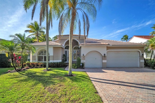 2623 Oakbrook Dr, Weston, FL 33332 - view of front of house featuring a garage, stucco siding, a front yard, and driveway