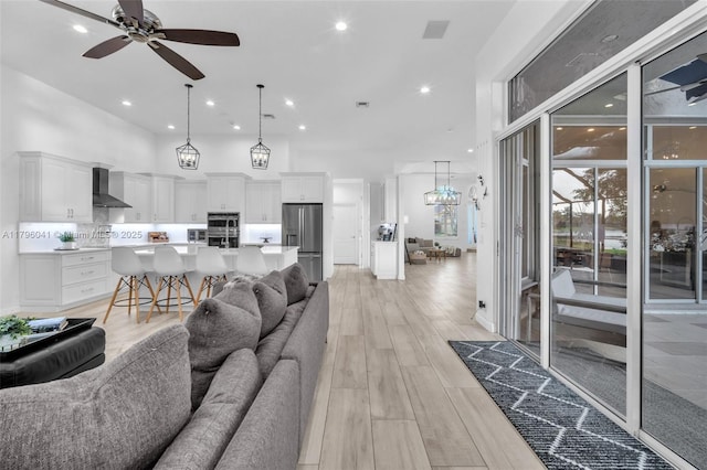 2623 Oakbrook Dr, Weston, FL 33332 - living area featuring a ceiling fan, light wood-style flooring, recessed lighting, and a towering ceiling