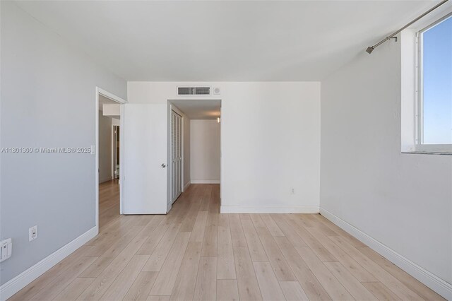 1345 Lincoln Unit 1006, Miami Beach, FL 33139 - spare room with baseboards, healthy amount of natural light, and light wood-style flooring