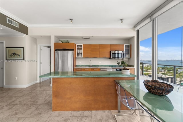3470 E Coast Ave Unit H1909, Miami, FL 33137 - kitchen featuring appliances with stainless steel finishes, brown cabinetry, crown molding, a sink, and glass insert cabinets