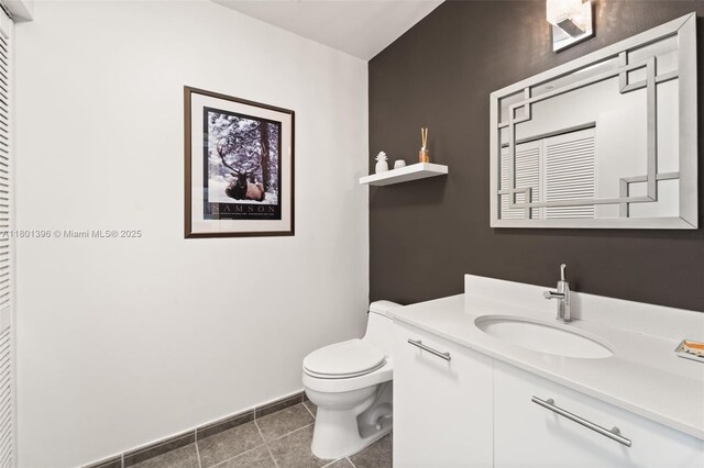 3470 E Coast Ave Unit H1909, Miami, FL 33137 - half bathroom featuring toilet, baseboards, vanity, and tile patterned flooring