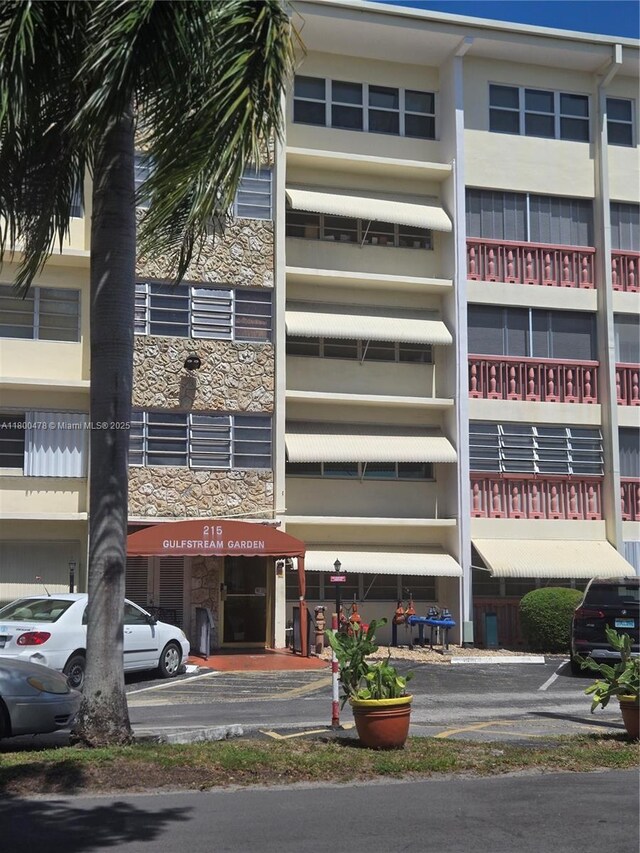 215 SE 3rd Ave Unit 401D, Hallandale Beach, FL 33009 - view of building exterior featuring uncovered parking