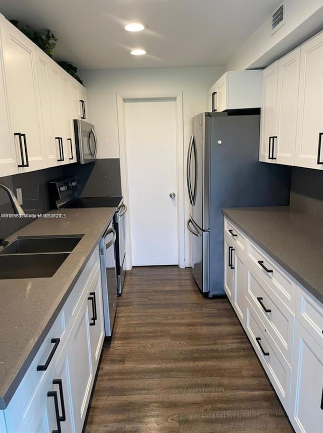 4164 Inverrary Dr Unit 301, Lauderhill, FL 33319 - kitchen featuring stainless steel appliances, a sink, white cabinetry, dark wood-style floors, and recessed lighting