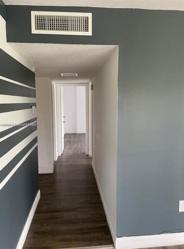 4164 Inverrary Dr Unit 301, Lauderhill, FL 33319 - corridor featuring dark wood-style floors, a textured ceiling, and baseboards