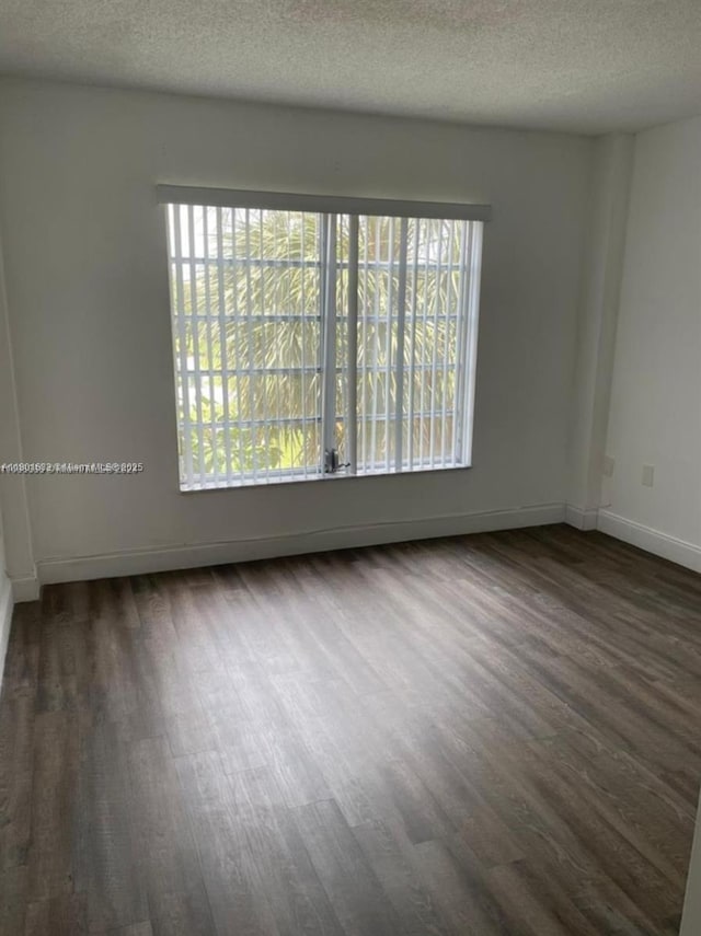 4164 Inverrary Dr Unit 301, Lauderhill, FL 33319 - empty room with dark wood-style flooring, a textured ceiling, and baseboards