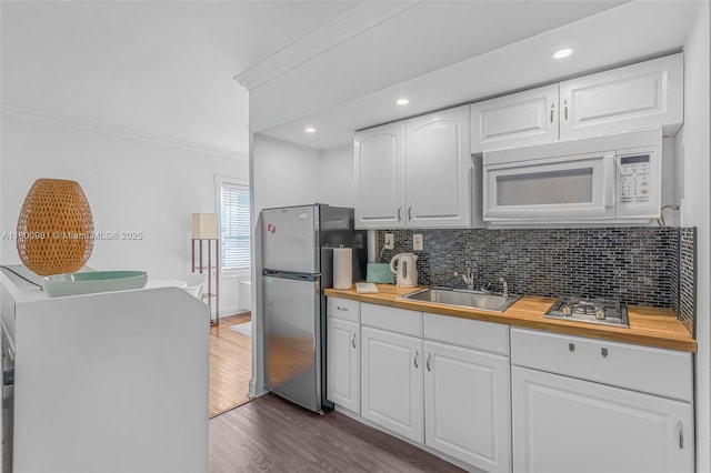 1555 Pennsylvania Ave Unit 209, Miami Beach, FL 33139 - kitchen with a sink, white microwave, freestanding refrigerator, butcher block counters, and ornamental molding