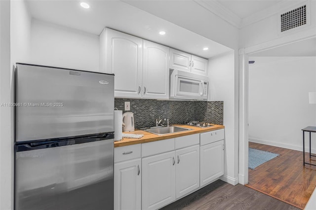 1555 Pennsylvania Ave Unit 209, Miami Beach, FL 33139 - kitchen with stainless steel appliances, wooden counters, ornamental molding, a sink, and dark wood-style floors