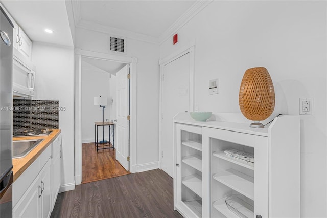 1555 Pennsylvania Ave Unit 209, Miami Beach, FL 33139 - hallway featuring dark wood-style flooring, ornamental molding, recessed lighting, baseboards, and a sink