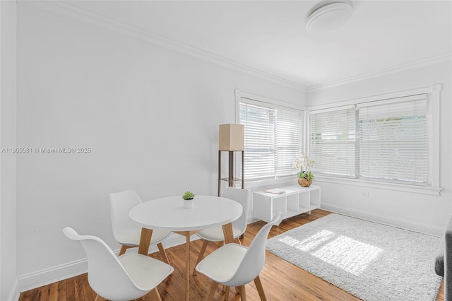 1555 Pennsylvania Ave Unit 209, Miami Beach, FL 33139 - dining area featuring crown molding, wood finished floors, and baseboards