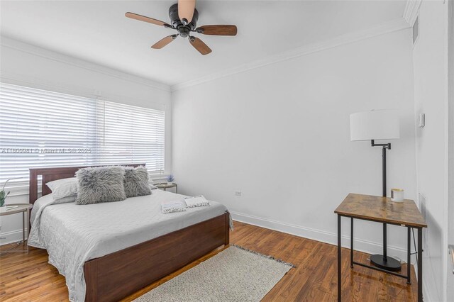 1555 Pennsylvania Ave Unit 209, Miami Beach, FL 33139 - bedroom featuring wood finished floors, ornamental molding, baseboards, and a ceiling fan