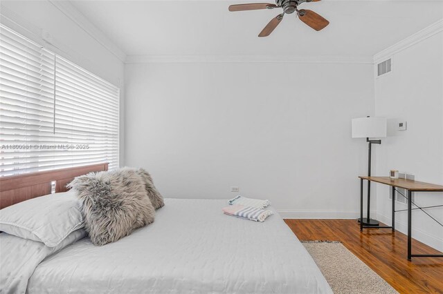 1555 Pennsylvania Ave Unit 209, Miami Beach, FL 33139 - bedroom featuring wood finished floors, crown molding, baseboards, and ceiling fan