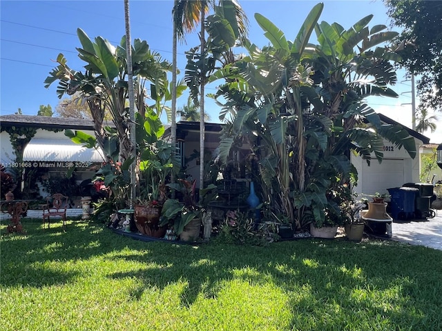 view of grassy yard with a garage
