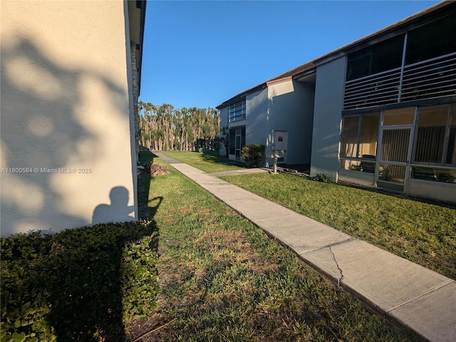 view of property's community with a lawn