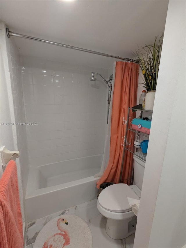 bathroom featuring toilet and shower / bath combo with shower curtain