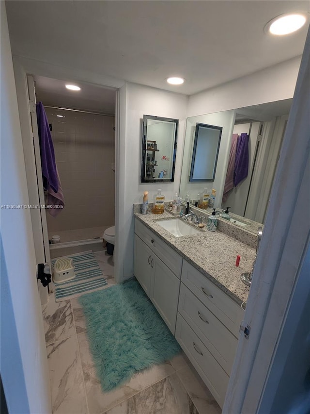 full bathroom featuring marble look tile flooring, toilet, vanity, a stall shower, and recessed lighting