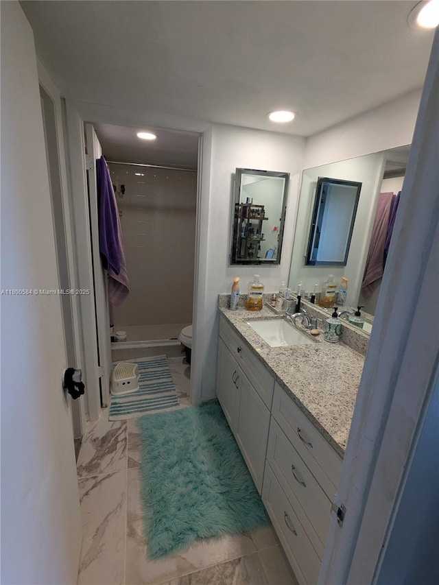 full bath featuring marble look tiles, a shower stall, vanity, toilet, and recessed lighting