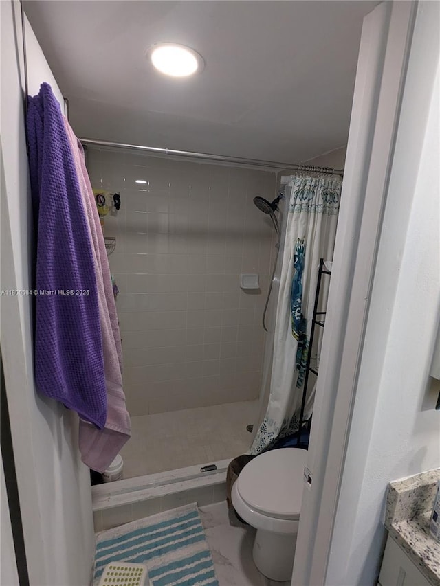 full bath featuring a shower stall, toilet, and vanity