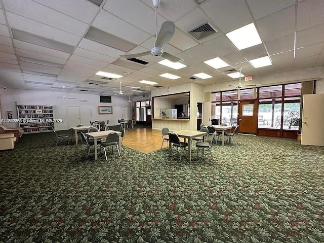 misc room featuring a ceiling fan, a paneled ceiling, and carpet flooring