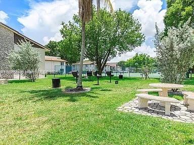 view of property's community featuring a yard