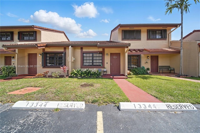 13344 SW 59th Ln, Miami, FL 33183 - view of front facade featuring stucco siding, a tiled roof, a front lawn, and uncovered parking