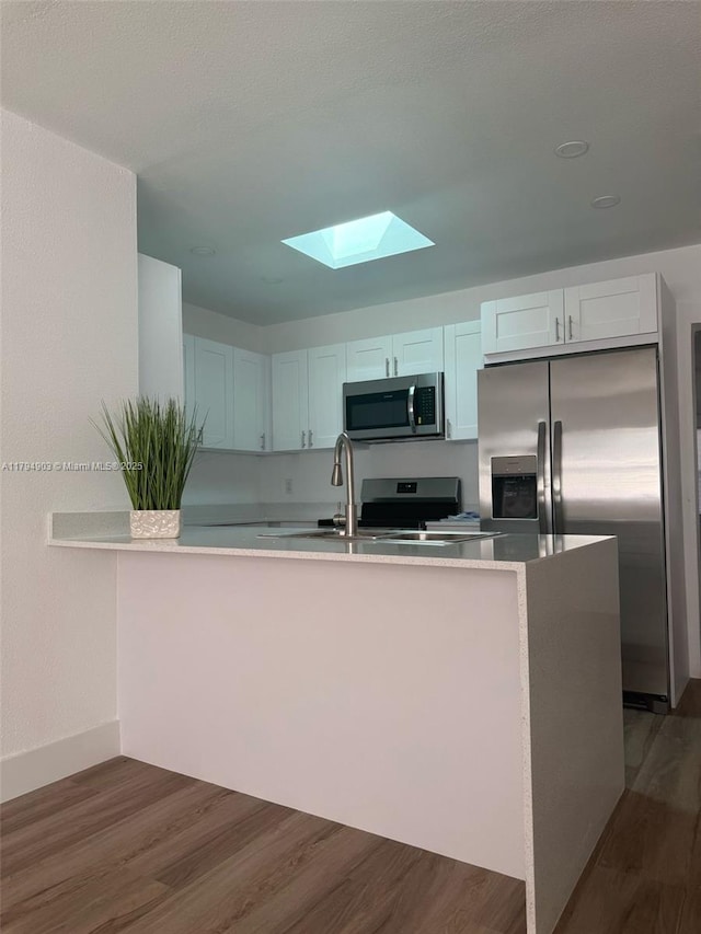 22011 Catherine Prt, Charlotte, FL 33952 - kitchen featuring appliances with stainless steel finishes, a skylight, and dark wood finished floors