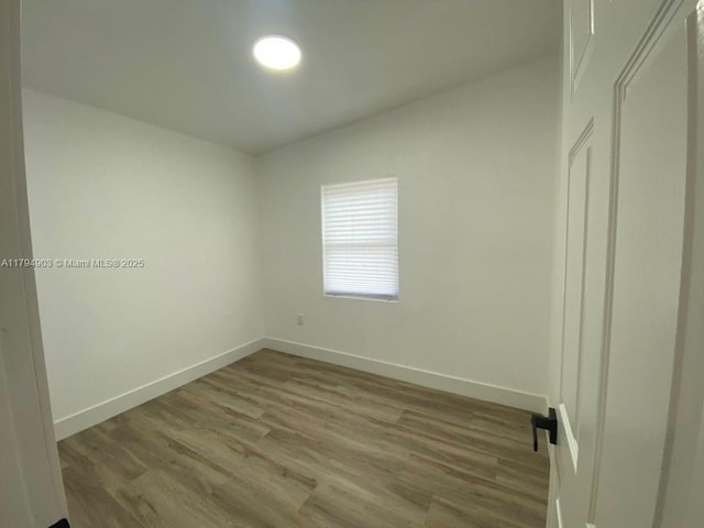 22011 Catherine Prt, Charlotte, FL 33952 - spare room featuring baseboards and wood finished floors