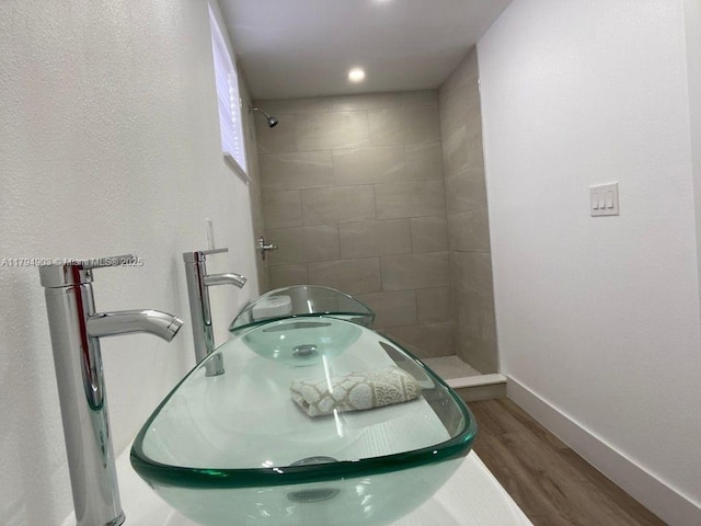 22011 Catherine Prt, Charlotte, FL 33952 - full bathroom featuring tiled shower, wood finished floors, and baseboards
