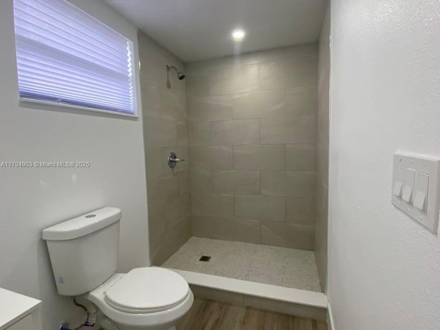 22011 Catherine Prt, Charlotte, FL 33952 - full bathroom featuring toilet, a tile shower, and wood finished floors